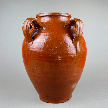 Antique Spanish terracotta orza with four sculptural handles and a rich red-brown glaze, hand-thrown in Toledo, Spain during the early 20th century. The vessel’s glossy surface and traditional form highlight Mediterranean pottery craftsmanship, perfect for rustic farmhouse or wabi sabi interiors.