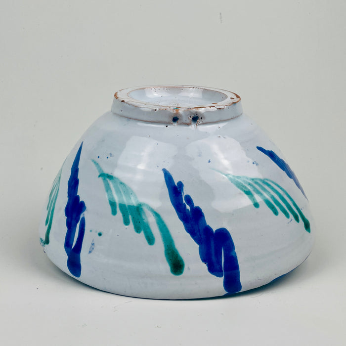 Decorative bowl underside suitable for tapas serving, fruit display, or a table centerpiece, and also works as wall hanging ceramic decor because of pierced hanging holes.