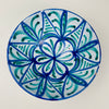 Granada pottery Fajalauza Decorative bowl with a hand-painted blue and green geometric floral pattern over an opaque white tin glaze. The exterior carries loose brush motifs, and the bowl’s weight and foot ring support stable tabletop placement. Rim chips and glaze losses are present, aligning with wabi sabi decor and vintage home decor styling.