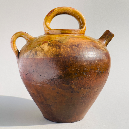Large antique French terracotta gargolette from the mid-19th century with ochre glaze, two handles, and tapered form used for water or wine storage.