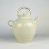 Antique French terracotta water jug in softly mottled white glaze, made as a substantial provincial cruche with two opposing handles and a narrow side spout. Its full ovoid form, hand-finished rim and warm cream patina create a sculptural pottery vase for French country decor or a collected folk pottery display.