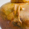 Tactile surface of aged terracotta ceramic water vessel with signs of centuries-old use.