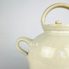 Large white glazed terracotta jug from France with an elongated ovoid body, gently tapered foot and hand-thrown rings visible beneath the glaze. Twin handles frame the wide neck, while the small pouring spout adds a distinctive architectural detail suited to farmhouse decor and neutral antique pottery collections.