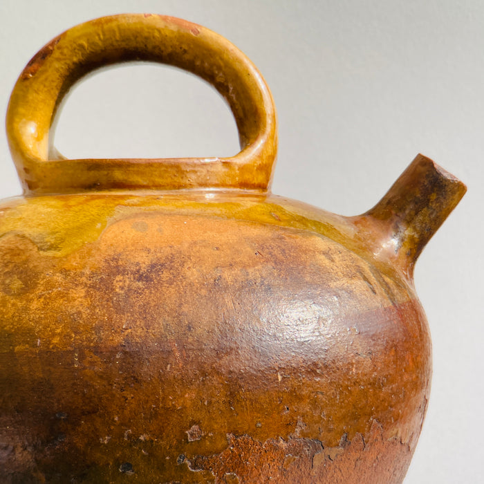 Spout and top handle detail on mid-19th century French ceramic water vessel with authentic burn marks and wear.