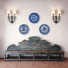 Three blue and white decorative plates on a wall above an old wooden bench. French Country Decor and Cottage Decor interiors
