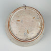 Spanish Fajalauza lebrillo bowl from Granada in tin glazed terracotta, painted in cobalt blue with a stylized flower, leaves, and small dotted accents in the center. The inner rim shows repeating blue wave bands with teardrop motifs. A wire hanger is attached on the reverse for wall display as Mediterranean decor.