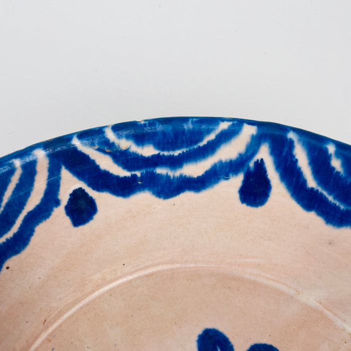 Spanish Fajalauza Ceramic plate with blue decorative pattern on a white background