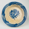 Blue and white Spanish decorative bowl in a traditional lebrillo form, featuring a hand-painted cobalt floral sprig with radiating petals and leaf scrolls. The wide rim band is painted in cobalt with soft transitions typical of brushed pigment on glaze. Ideal for Mediterranean decor dining, vintage kitchen display, and ceramic wall decor collections.