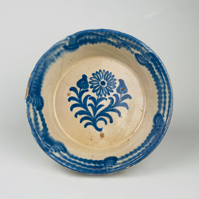 Antique Spanish lebrillo bowl in tin glazed terracotta with cobalt blue floral sprig design and a wide blue rim band. The deep profile supports serving olives, bread, and citrus for Spanish tapas tables, and the blue and white palette pairs well with Japandi decor, wabi sabi decor, farmhouse decor, and Mediterranean decor interiors.