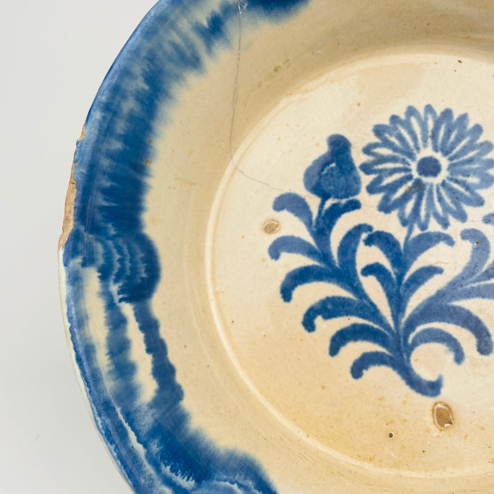 Antique Spanish blue and white ceramic bowl in lebrillo form, tin glazed terracotta with cobalt blue floral sprig design and a wide rim border. The proportions suit serving and display, including tapas, bread, and fruit on a Spanish tabletop. The color palette works with coastal decor, cottage decor, and farmhouse decor kitchen styling.