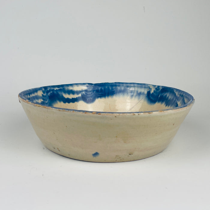 Antique Spanish Granada style Fajalauza bowl, tin glazed terracotta with cobalt blue painted floral sprig and wide rim band. Deep serving bowl shape for tapas, olives, and citrus, and decorative use on open shelving. The blue and white palette supports Mediterranean decor, wabi sabi decor, and coastal decor styling without overpowering a neutral space.