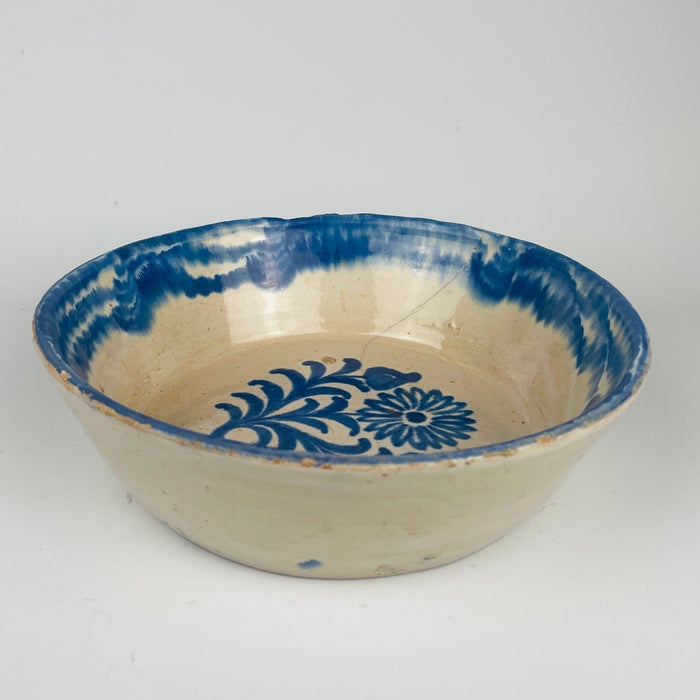 Spanish lebrillo bowl in blue and white tin glazed terracotta with cobalt floral decoration and a strong rim border band. Diameter 24.7 cm and height 7.7 cm. Practical for tapas serving and fruit presentation, while also functioning as a decorative ceramic object for farmhouse decor kitchens, Mediterranean decor dining, and Spanish pottery wall arrangements.