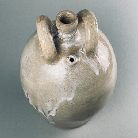 Wabi-sabi style handcrafted jug with soft earthy glaze tones.