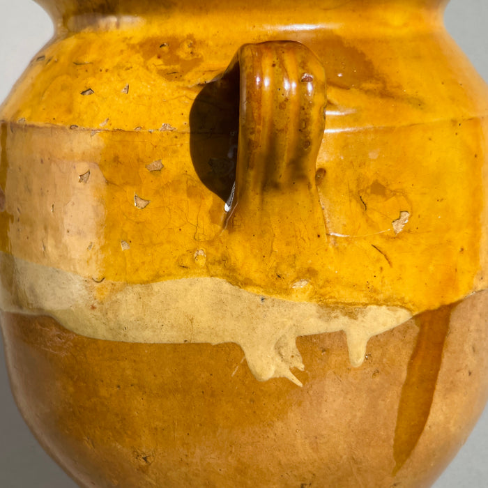 Traditional French farmhouse pottery confit jar with ochre glaze and red clay base, authentic antique kitchen storage vessel circa 1880–1900.
