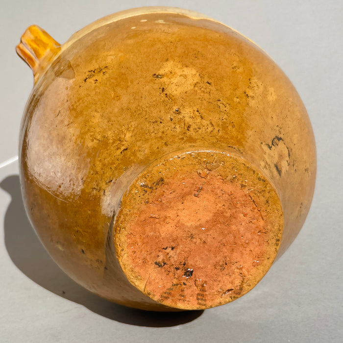Large 19th-century Southwest France pottery vessel with ochre glaze, twin handles, and rustic character ideal for Mediterranean interior styling.
