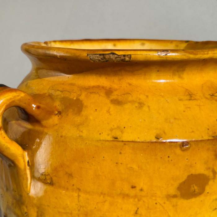 Detailed view of vintage Southwest French confit jar with visible glaze pooling, rim wear, and rustic handmade charm.