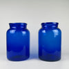 body of one vase, showing density variations in the cobalt pigment and natural air inclusions inside the glass. These qualities demonstrate pre-industrial glassmaking techniques. The deep blue colour makes the vase a strong candidate for French country decor, rustic farmhouse displays, and Mediterranean style arrangements.