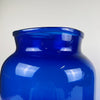 Detailed of the rim section on one antique French vase, showing 19th century hand blown glass with clear mouth irregularities, thickness variation, and light distortion marks. These features confirm early craftsmanship and add authenticity. Ideal for collectors of antique glass, pharmacy glassware, or those styling wabi sabi or japandi interiors