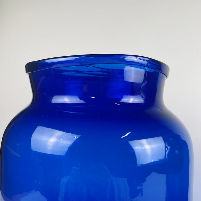 Detailed of the rim section on one antique French vase, showing 19th century hand blown glass with clear mouth irregularities, thickness variation, and light distortion marks. These features confirm early craftsmanship and add authenticity. Ideal for collectors of antique glass, pharmacy glassware, or those styling wabi sabi or japandi interiors