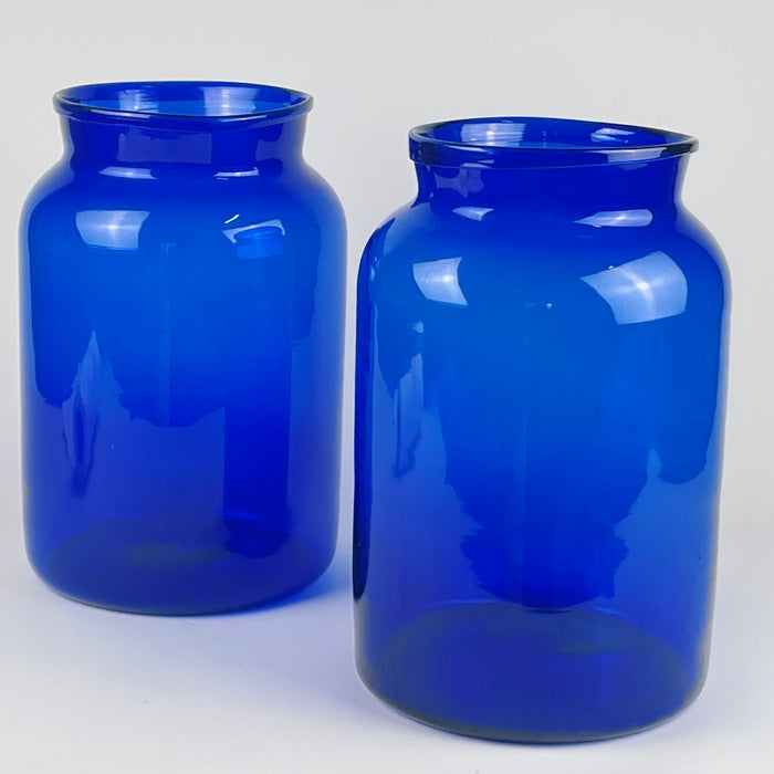 19th century French cobalt blue glass vase, highlighting the deep, saturated colour traditionally achieved using pigments such as smalt and cobalt. The rim shows pronounced irregularities and uneven thickness typical of hand blown glass craftsmanship. This detailed angle emphasizes the piece’s suitability for contemporary rustic decor, statement glass displays, and Mediterranean inspired interiors.