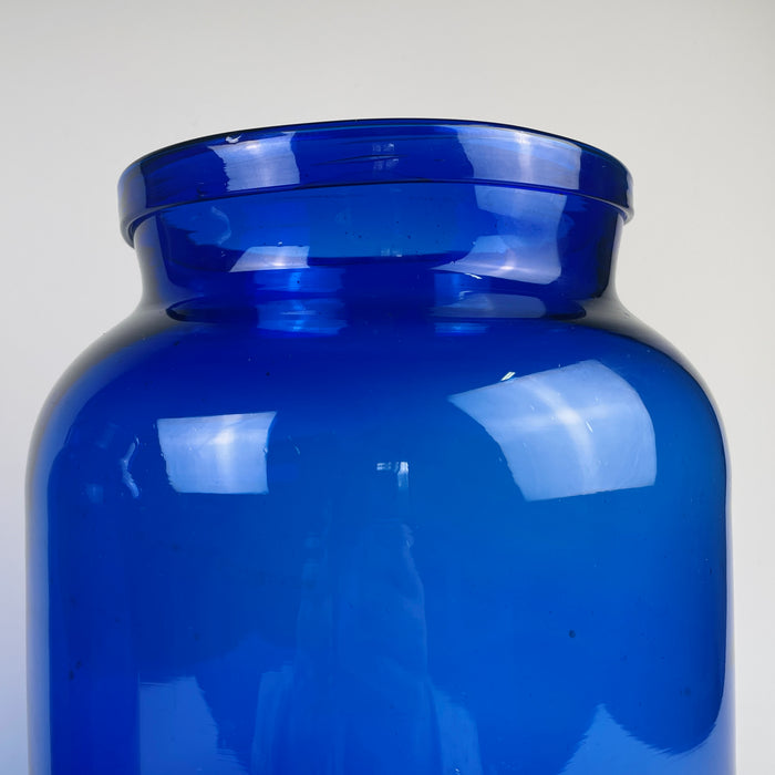 Photograph of the body of one vase, showing density variations in the cobalt pigment and natural air inclusions inside the glass. These qualities demonstrate pre-industrial glassmaking techniques. The deep blue colour makes the vase a strong candidate for French country decor, rustic farmhouse displays, and Mediterranean style arrangements.
