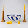 Large Spanish Fajalauza lebrillo bowl by Cerámica Los Arrayanes, made from glazed terracotta earthenware and hand painted in cobalt blue over a warm cream ground. The interior border combines rhythmic wavy brushstrokes, looping geometric forms and bold floral marks, creating expressive Granada pottery for Mediterranean decor or ceramic wall art.