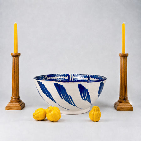 Large Spanish Fajalauza lebrillo bowl by Cerámica Los Arrayanes, made from glazed terracotta earthenware and hand painted in cobalt blue over a warm cream ground. The interior border combines rhythmic wavy brushstrokes, looping geometric forms and bold floral marks, creating expressive Granada pottery for Mediterranean decor or ceramic wall art.