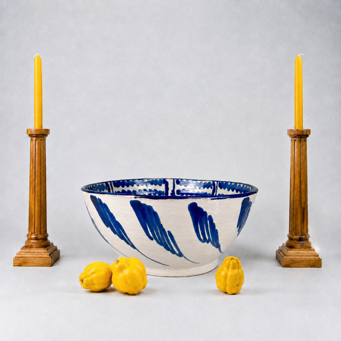 Large Spanish Fajalauza lebrillo bowl by Cerámica Los Arrayanes, made from glazed terracotta earthenware and hand painted in cobalt blue over a warm cream ground. The interior border combines rhythmic wavy brushstrokes, looping geometric forms and bold floral marks, creating expressive Granada pottery for Mediterranean decor or ceramic wall art.