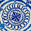 Exterior detail of the Spanish Los Arrayanes bowl showing a broad cobalt blue motif beneath the painted rim, with natural tonal variation where the pigment pools and thins. The cream glazed earthenware surface retains small artisan irregularities, supporting the handmade character of this large Fajalauza serving bowl and Mediterranean ceramic decor.