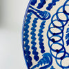 Blue and white Spanish Fajalauza bowl by Cerámica Los Arrayanes, with an open flared profile and a richly decorated interior of floral, looping and scalloped motifs. The cobalt brushwork continues across the outer wall in broad gestural marks, creating a large handmade Granada pottery centerpiece suited to serving, tabletop display or wall decor.