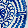 Large Spanish Fajalauza lebrillo bowl with its deep interior fully visible, revealing concentric cobalt blue ornament around a central floral medallion. Hand painted scalloped bands, suspended leaf forms and overlapping loops cover the cream glazed terracotta, while broad blue strokes decorate the exterior of this substantial Granada pottery bowl.