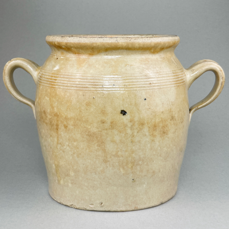 Rustic pale glazed confit jar from late 19th century France. French country kitchen pottery vessel with ribbed banding. Old world farmhouse aesthetic using French pottery.

