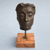 Signed Italian modernist sculpture titled Maschera, featuring closed eyes and refined bronze facial detail on a solid marble base.