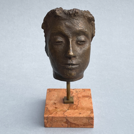 Signed Italian modernist sculpture titled Maschera, featuring closed eyes and refined bronze facial detail on a solid marble base.