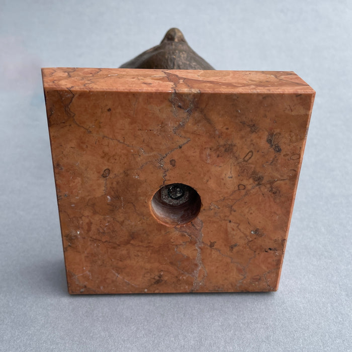 Detail of the red marble veining beneath the sculpture, creating a strong base for the piece.