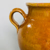 Detailed view of authentic antique glaze loss and surface texture on rustic French confit jar.