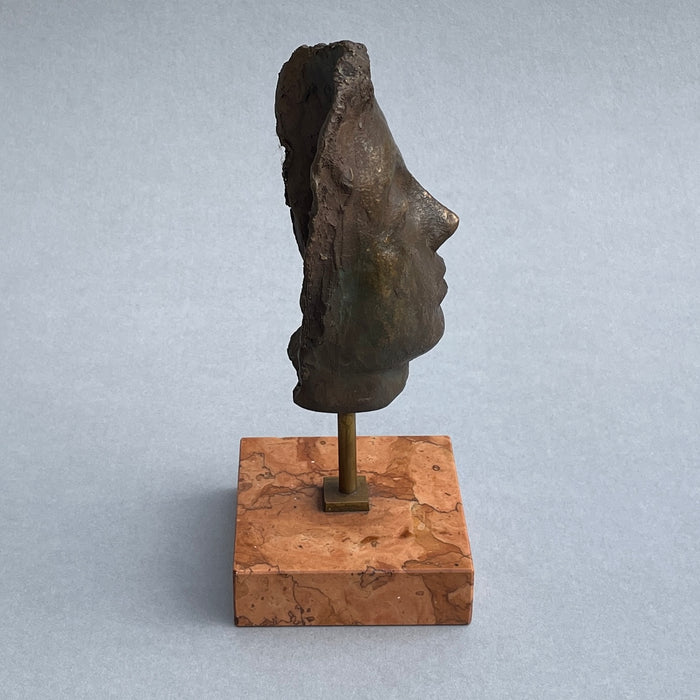 Modernist Italian bronze head on display against a neutral backdrop, emphasizing its artistic and collectible value.