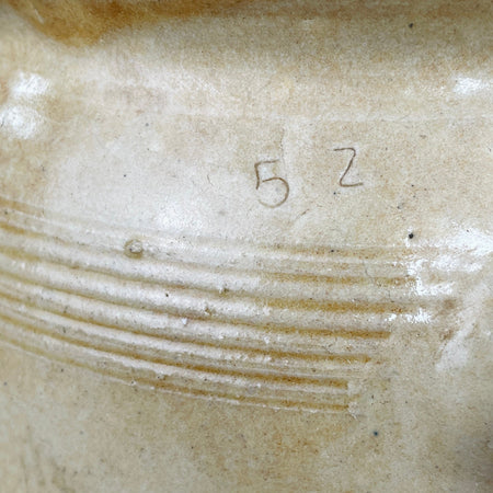Hand-incised “52” mark on vintage stoneware pot.