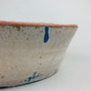 Side profile of the Spanish lebrillo showing the depth of the terracotta bowl and the hand-applied cobalt blue designs climbing the curved interior walls, emphasizing its rustic Andalusian craftsmanship and utilitarian origins.