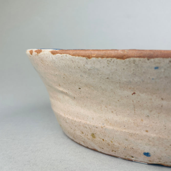 Angled image of the lebrillo bowl highlighting its large 36.5 cm diameter, deep 9 cm profile, and decorative interior surface with Moorish border patterns and a bold bird motif, suitable as a striking Mediterranean centerpiece or wall display.