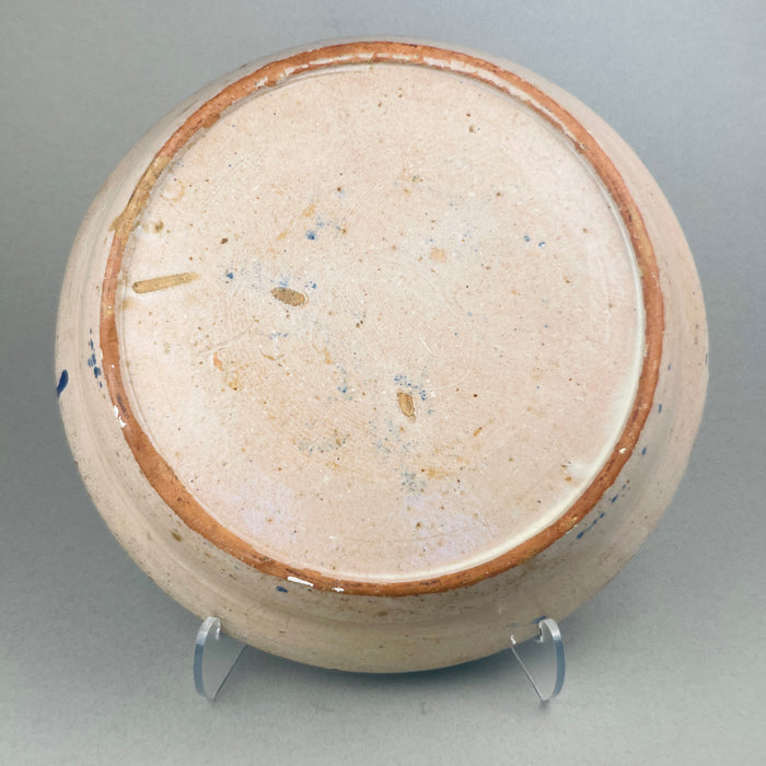 Reverse view of the large Spanish bowl showing the worn terracotta base with concentric turning marks and aged patina, highlighting the traditional hand-thrown technique used in Fajalauza workshops in Granada.