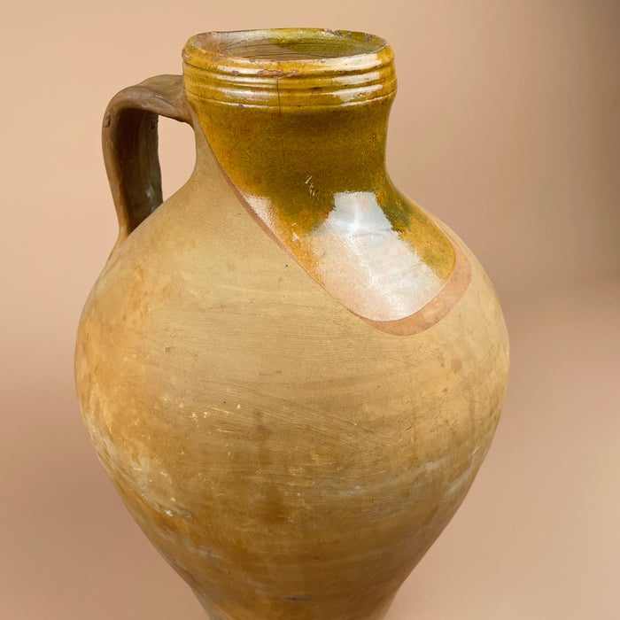 Rear angle of the rustic Spanish water jug, showing age wear, glaze drips, and hand-built texture. The natural earthen tone complements organic modern and farmhouse decor, adding authenticity to Mediterranean-inspired interiors.