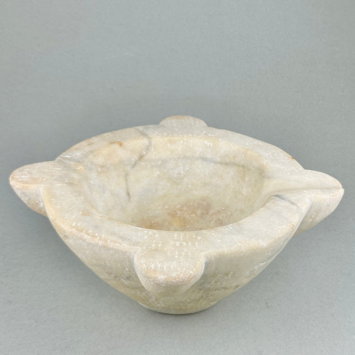 Hand-carved marble antique mortar, showcasing French craftsmanship and worn surface from 18th-century use.
