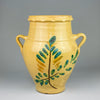 Antique Spanish orza decorative vasefrom Lucena, Córdoba, with yellow terracotta glaze and hand-painted green and brown foliate design, featuring two looped handles and a wide opening. A traditional Spanish storage vessel dating to the early 20th century.