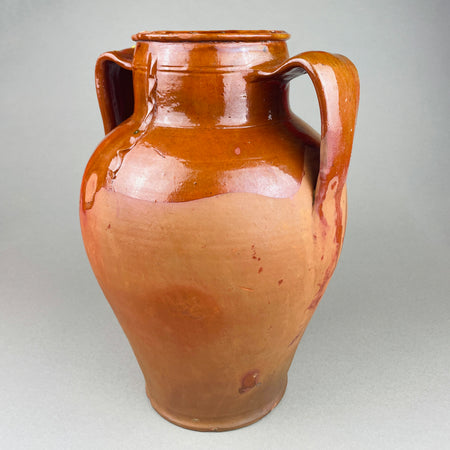 Detail of the right handle and upper body on a large decorative pot, with semi-gloss brown glaze over red clay and visible firing speckles. The handle’s squared profile emphasizes the utilitarian heritage while presenting as vintage home decor today, ideal for Mediterranean decor shelving or French provincial styling.