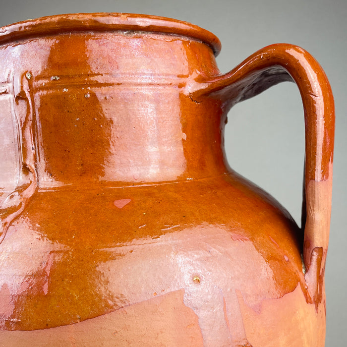 Top view into a large decorative terracotta vase with twin handles, showing the thick rounded rim, interior wear, and the contrast between glossy brown glaze and exposed clay at the lip. This antique decorative pottery piece reads well in wabi sabi and Japandi rooms where texture and patina are key.