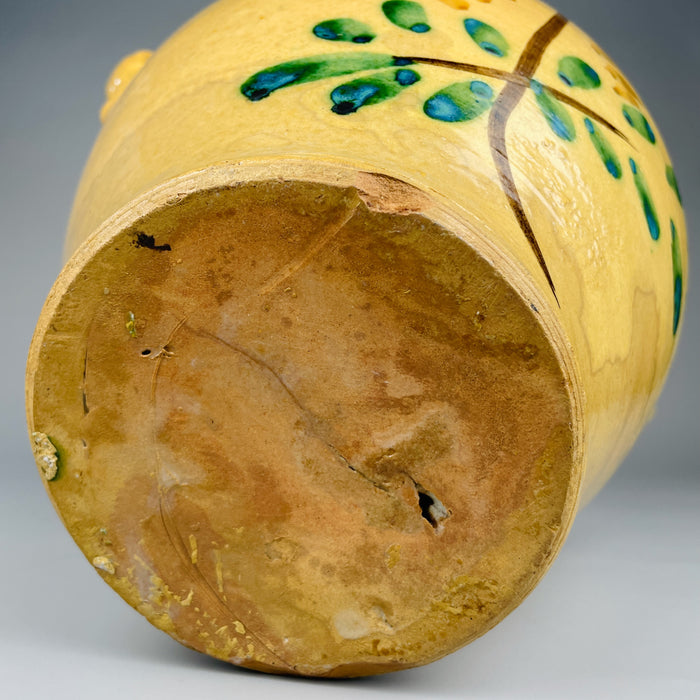 Underside of the antique orza jar showing the raw terracotta base, natural firing marks, and signs of age. This unglazed base confirms its handmade nature and use as a utilitarian vessel in early 20th-century Spain.