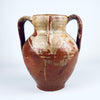 Antique Spanish glazed terracotta vase from nineteenth century Castile, formed as a traditional two handled orza pottery jar. The rounded red clay body has a short neck, open mouth, amber brown glaze across the upper section, exposed terracotta below, and age worn patina suited to Mediterranean decor or farmhouse decor.