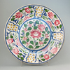 Front view of large antique English polychrome platter from the late Victorian era, featuring vibrant Arts and Crafts floral design.