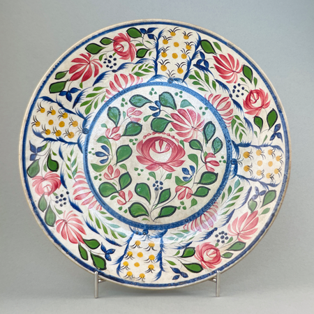 Front view of large antique English polychrome platter from the late Victorian era, featuring vibrant Arts and Crafts floral design.